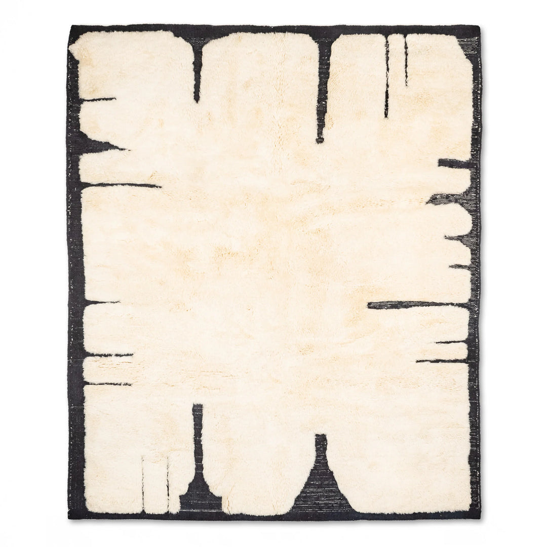 Abstract cream and black Moroccan wool rug with minimalist design and faded diamond patterns, ideal for modern and boho decor.