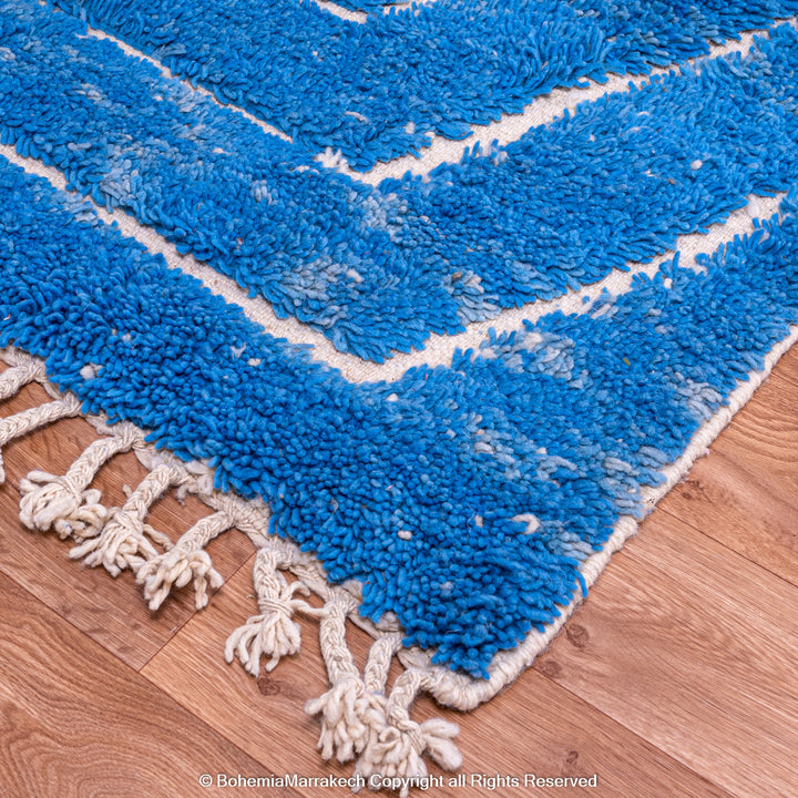 Multicolored Moroccan Boujaad Rug handmade with wool, featuring vibrant pink, yellow, and blue Berber patterns.