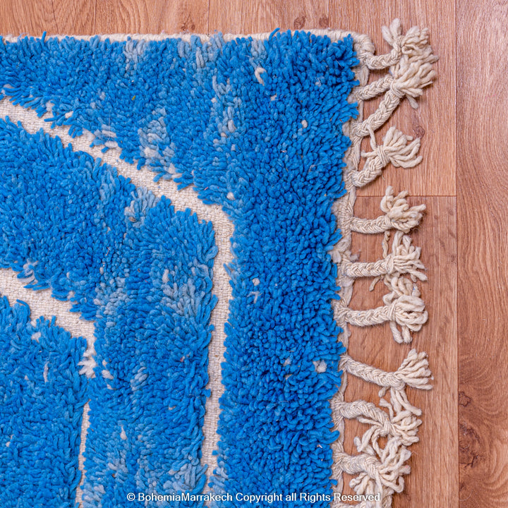 Multicolored Moroccan Boujaad Rug handmade with wool, featuring vibrant pink, yellow, and blue Berber patterns.