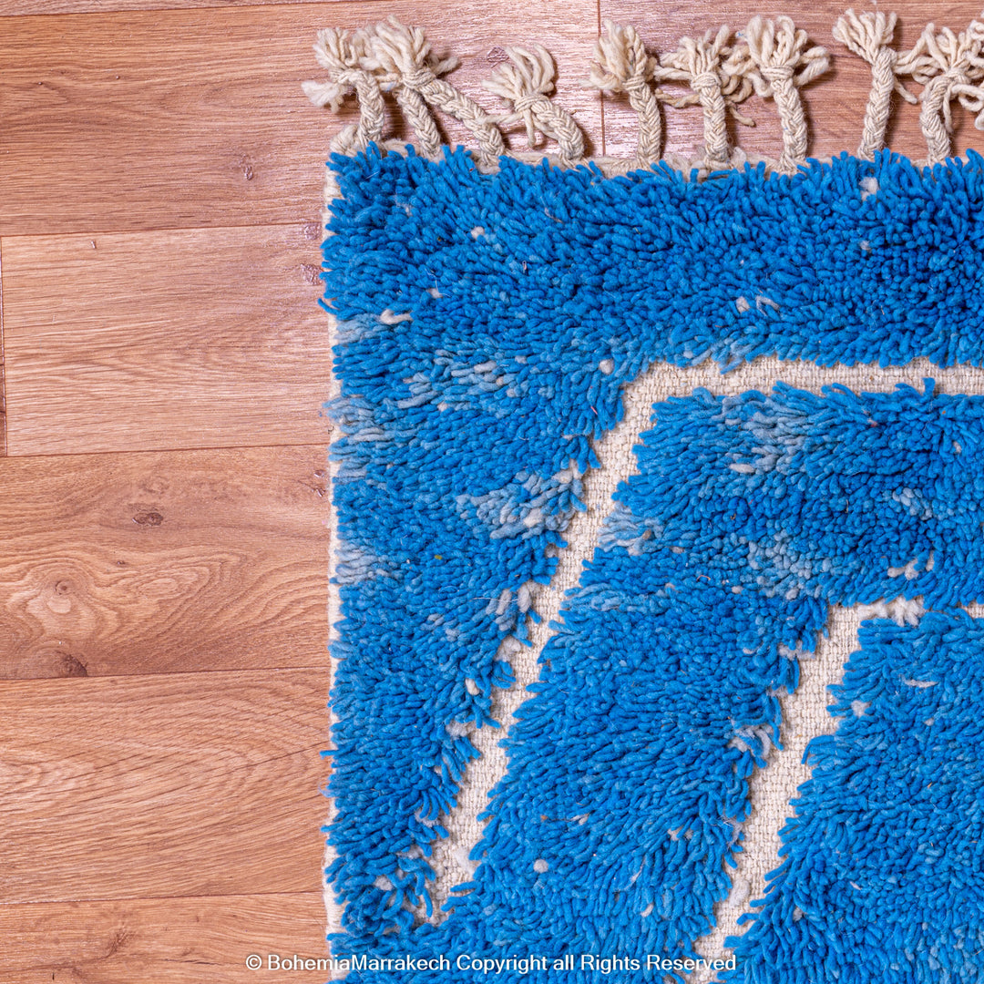 Multicolored Moroccan Boujaad Rug handmade with wool, featuring vibrant pink, yellow, and blue Berber patterns.
