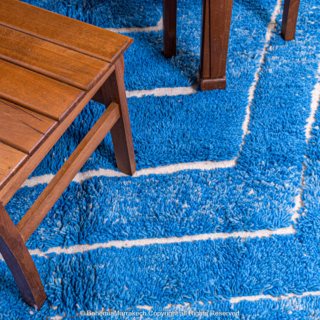 Multicolored Moroccan Boujaad Rug handmade with wool, featuring vibrant pink, yellow, and blue Berber patterns.