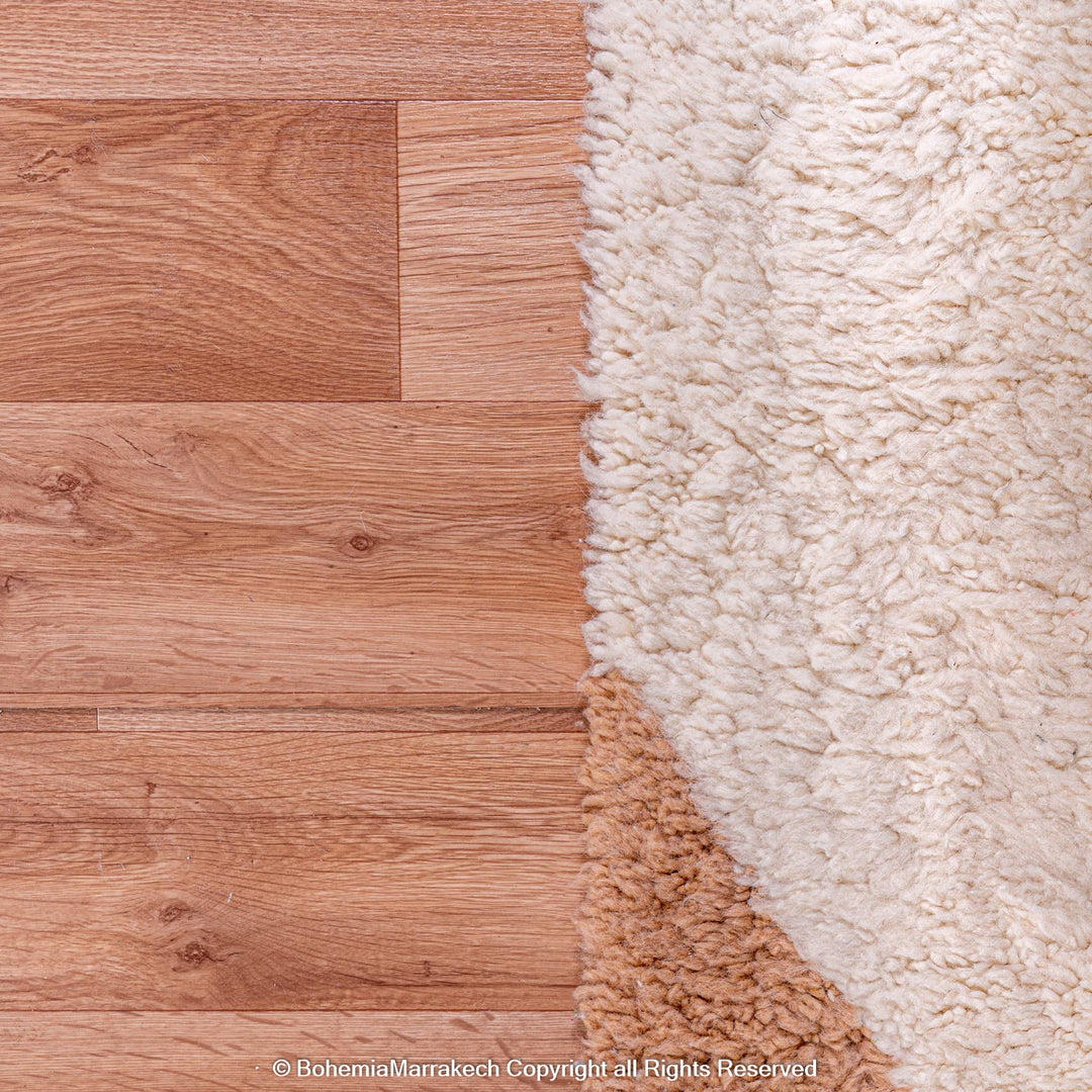 Ivory wool shag Moroccan rug on hardwood floor close-up