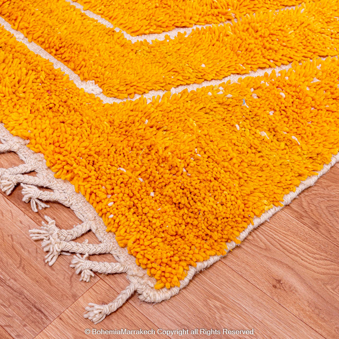 Orange Moroccan wool rug with chevron pattern and shag texture