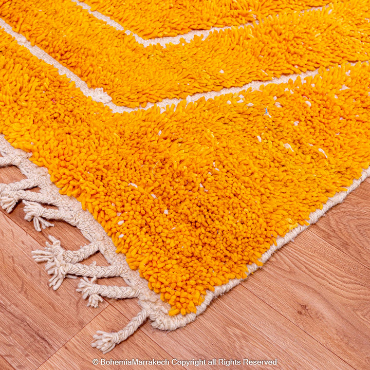 Orange Moroccan wool rug with chevron pattern and shag texture