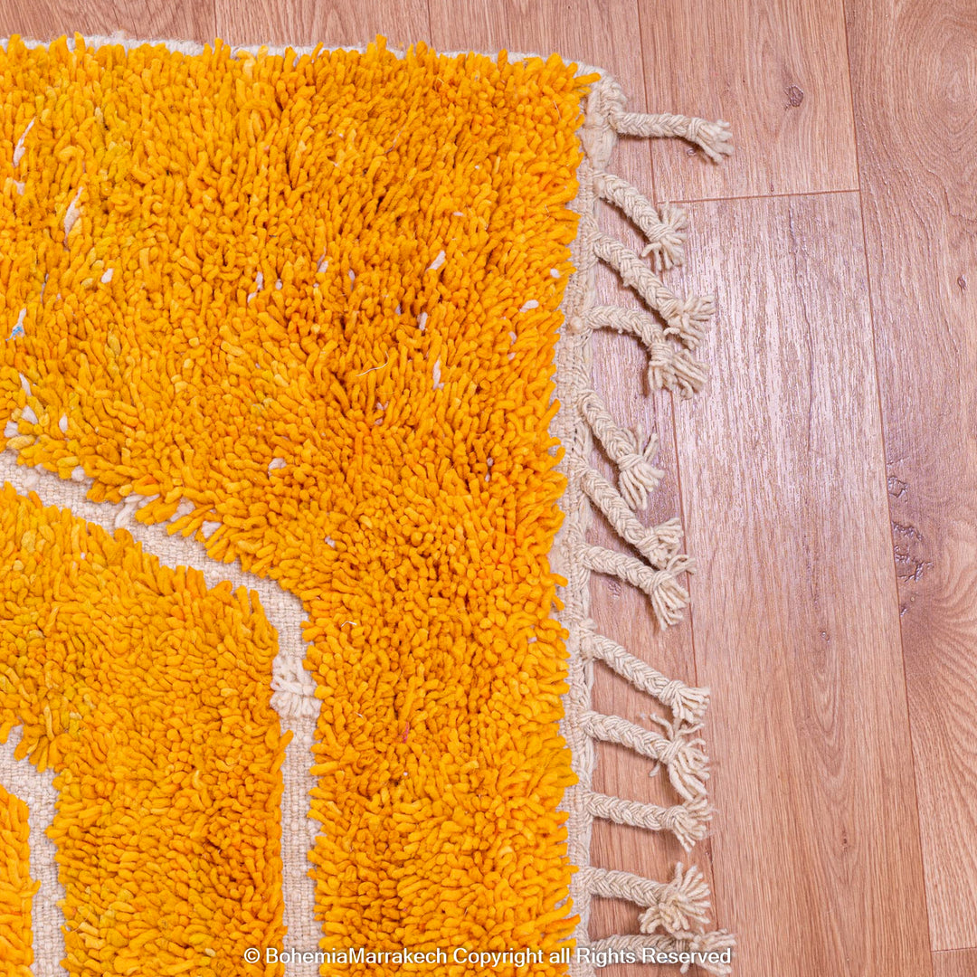 Orange Moroccan wool rug with chevron pattern and shag texture