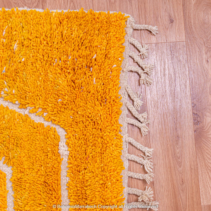 Orange Moroccan wool rug with chevron pattern and shag texture
