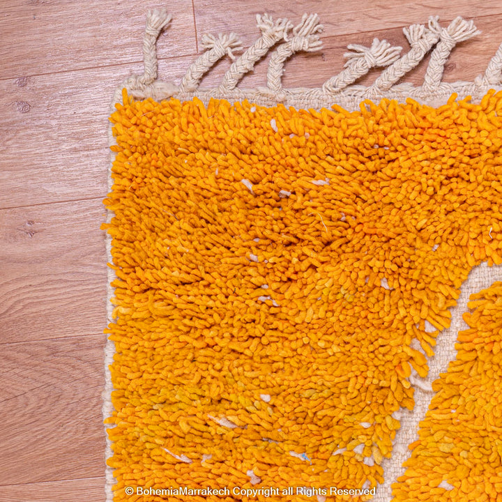 Orange Moroccan wool rug with chevron pattern and shag texture