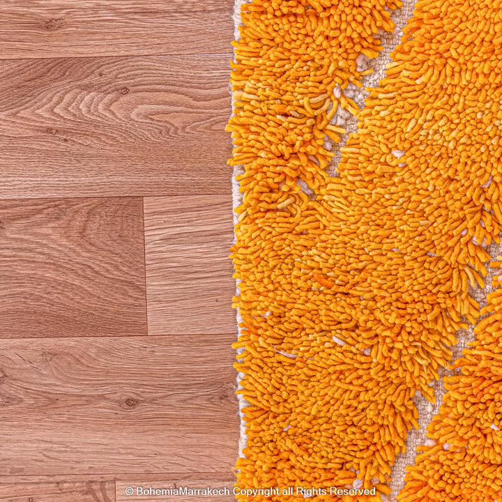 Orange Moroccan wool rug with chevron pattern and shag texture