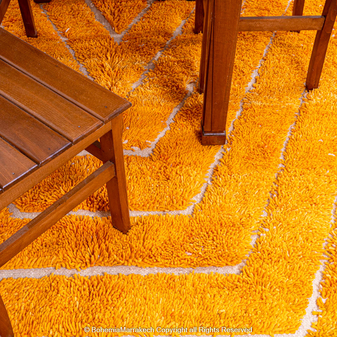 Orange Moroccan wool rug with chevron pattern and shag texture