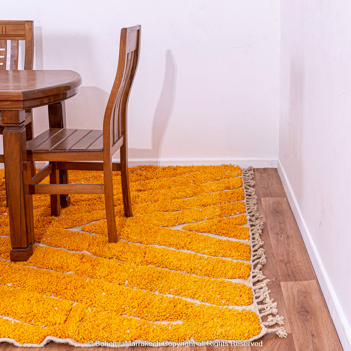 Orange Moroccan wool rug with chevron pattern and shag texture