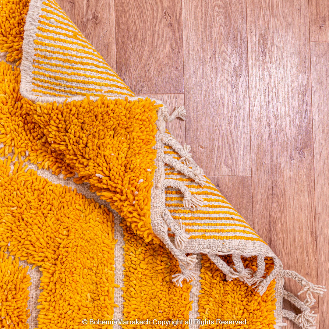 Orange Moroccan wool rug with chevron pattern and shag texture