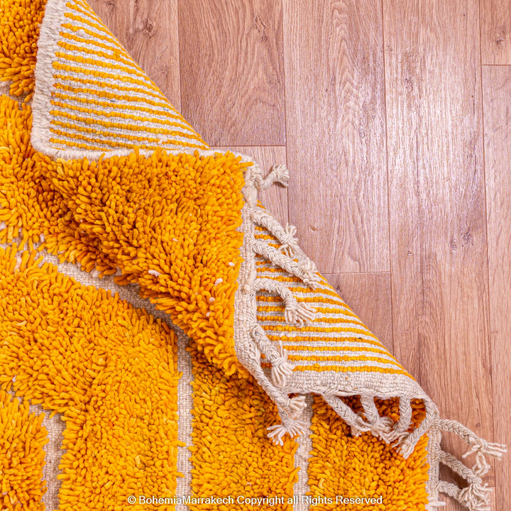 Orange Moroccan wool rug with chevron pattern and shag texture