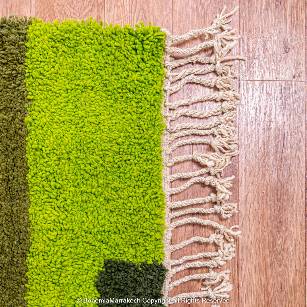 Handmade green geometric Moroccan wool rug with modern pattern