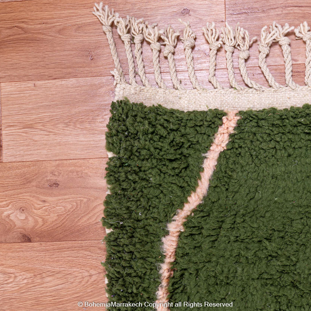 Green Moroccan rug with pink abstract desert motif design, handmade in wool