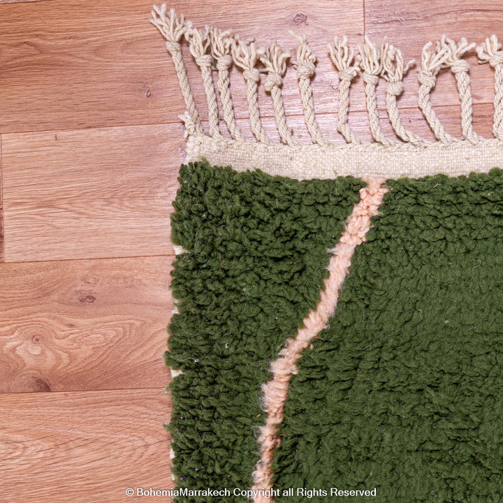 Green Moroccan rug with pink abstract desert motif design, handmade in wool