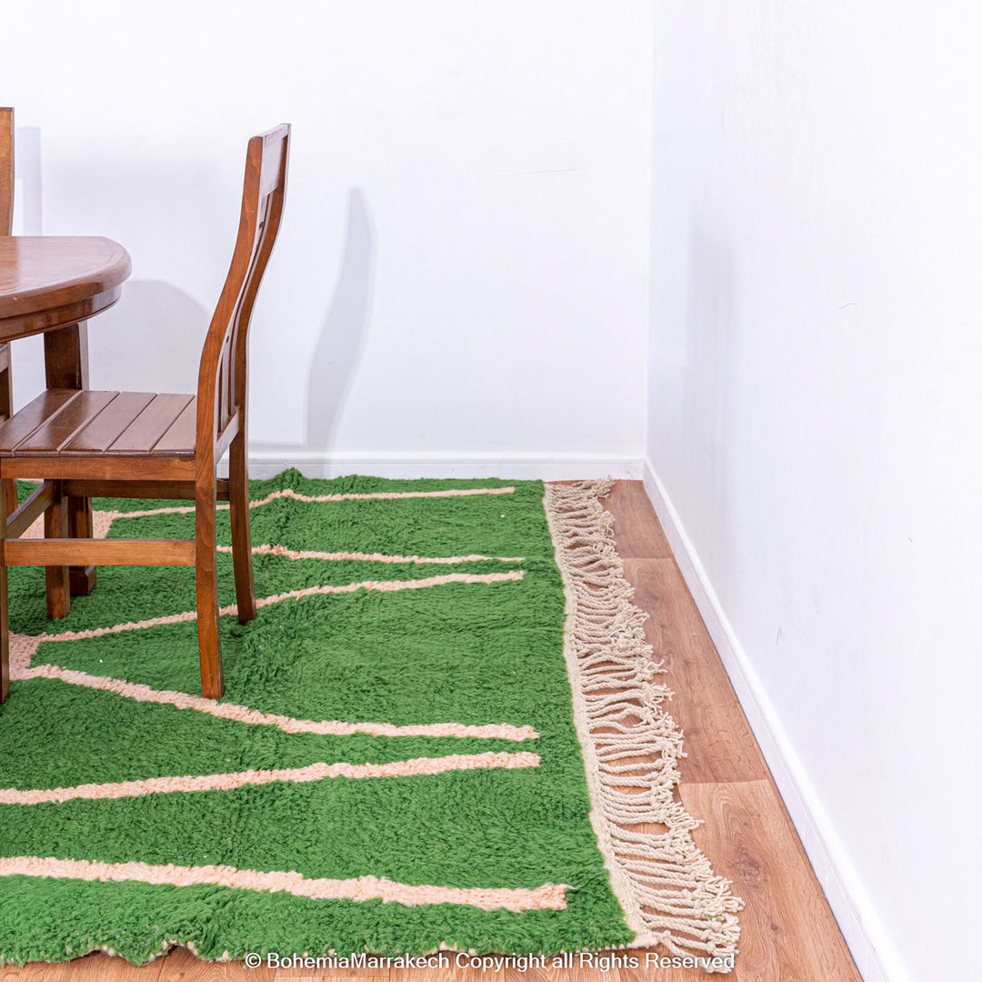 Green Moroccan rug with pink abstract desert motif design, handmade in wool