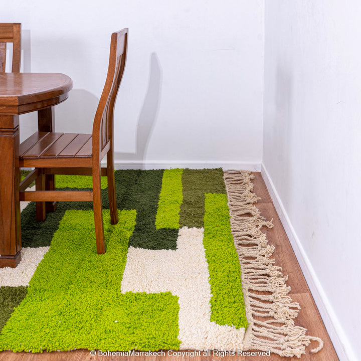 Handmade green geometric Moroccan wool rug with modern pattern