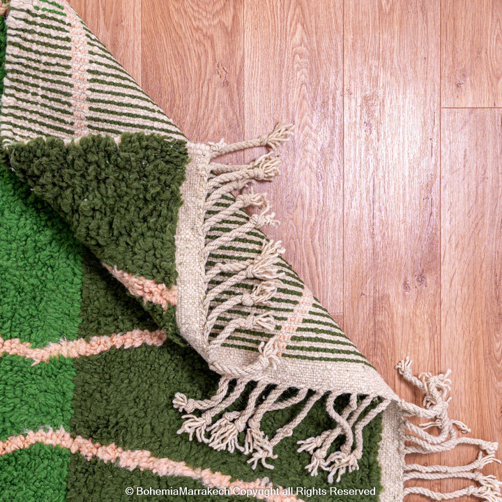 Green Moroccan rug with pink abstract desert motif design, handmade in wool