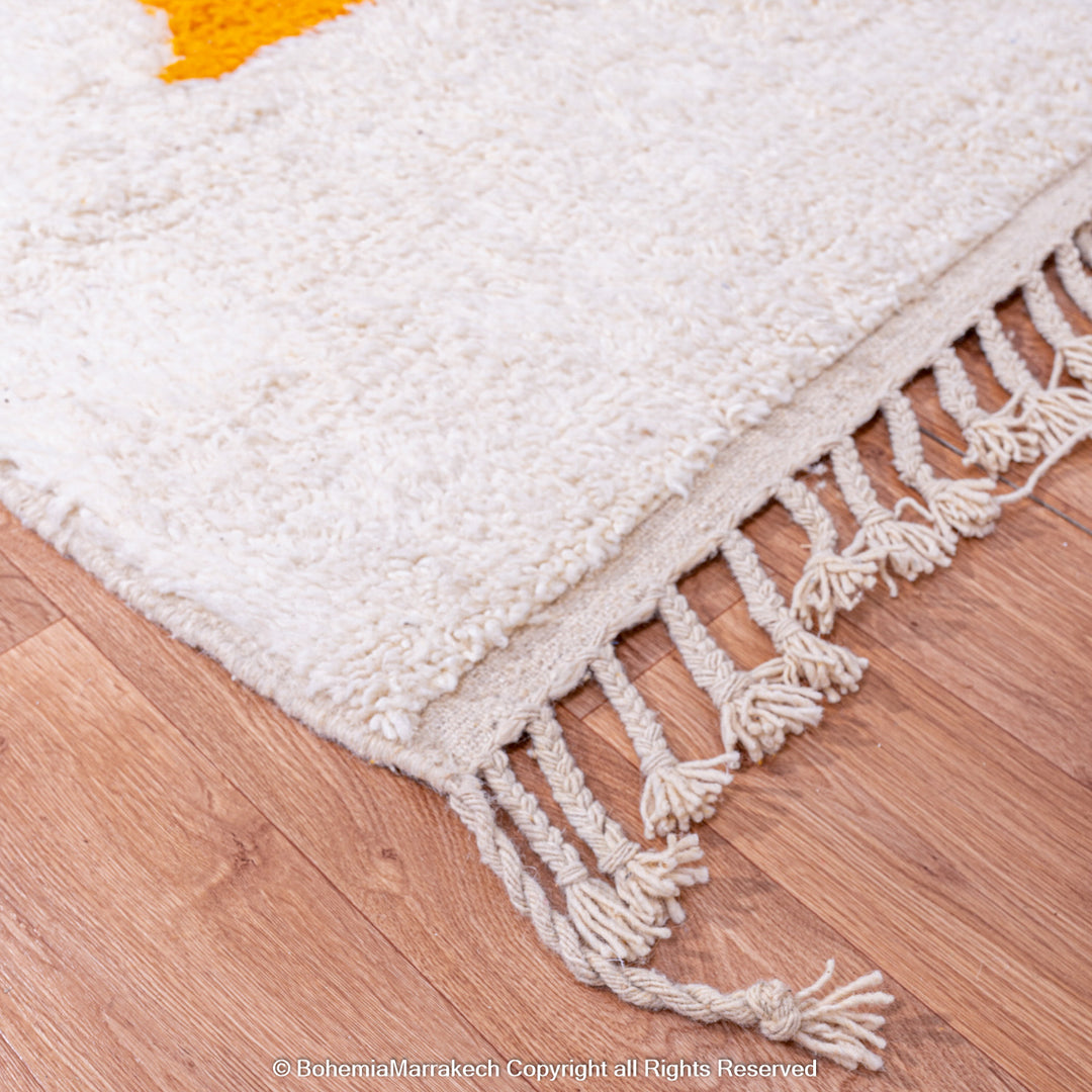 Handmade Moroccan wool rug with abstract orange and beige block design on cream background
