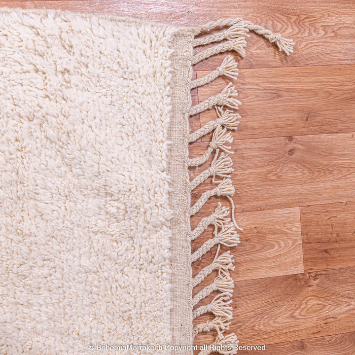 Handmade Moroccan wool rug with abstract orange and beige block design on cream background