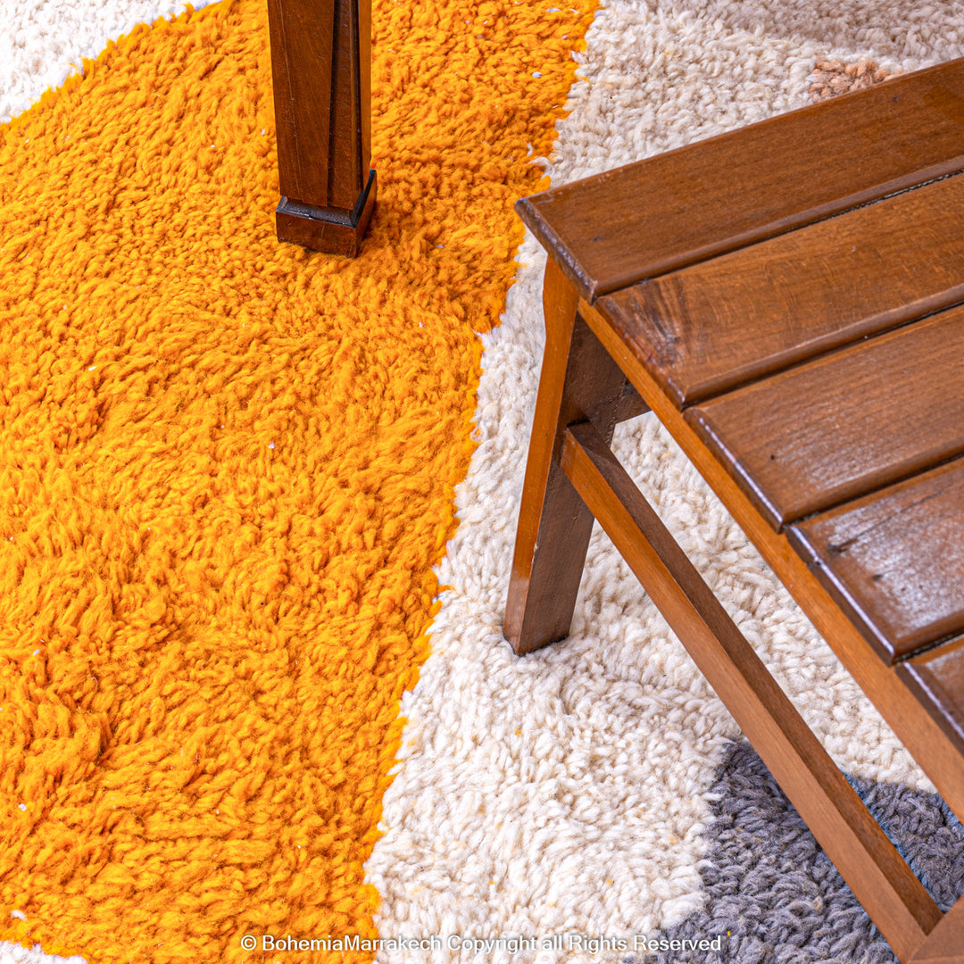 Handmade Moroccan wool rug with abstract orange and beige block design on cream background