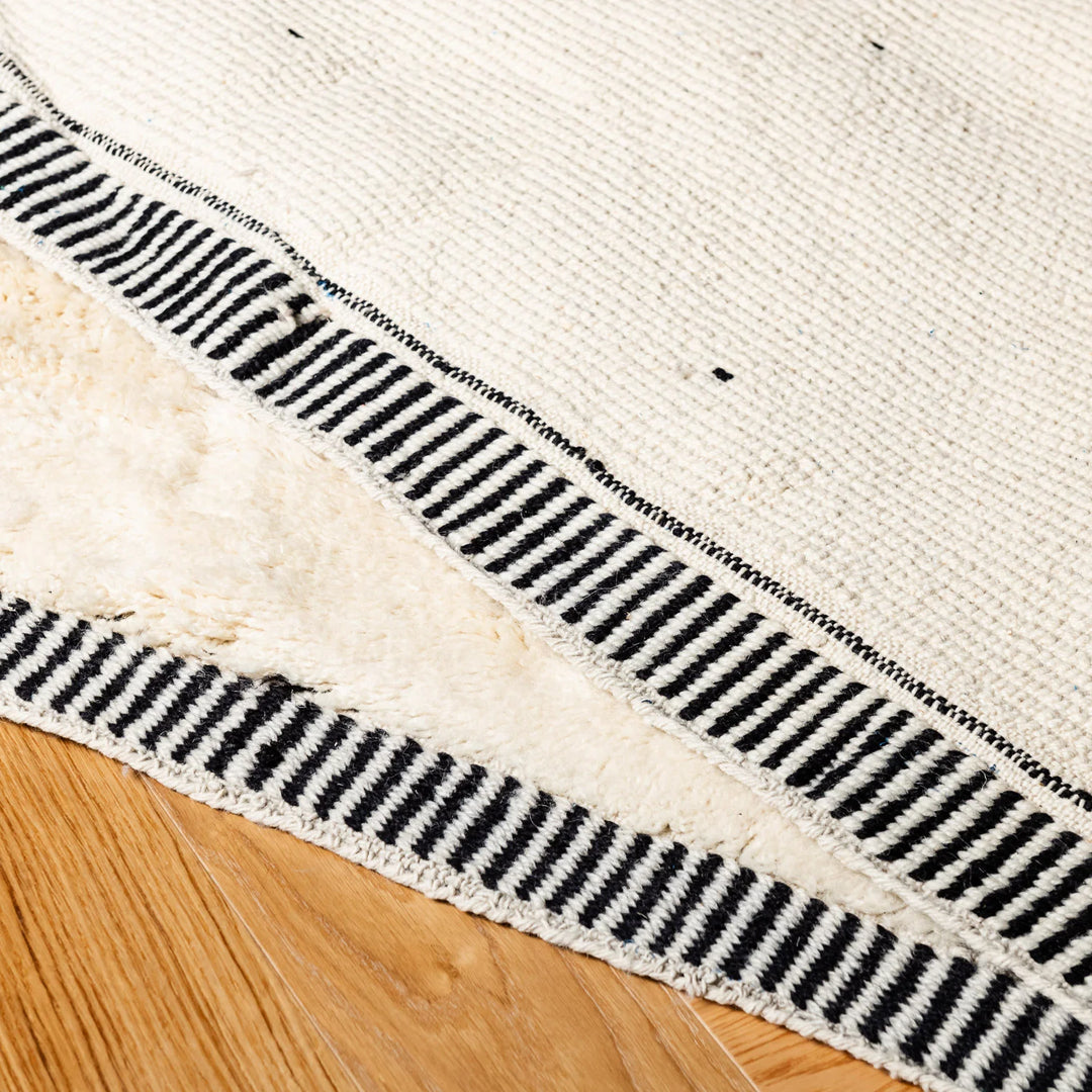 Close-up of Beni Ourain Moroccan rug showing diamond and dotted pattern detail.
