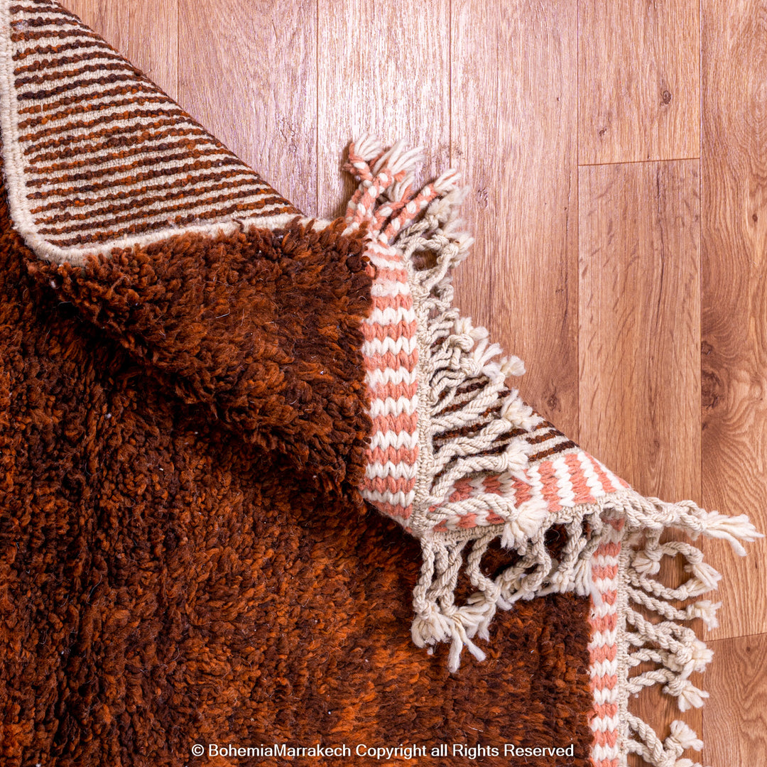 Desert-inspired Moroccan rug with earthy red and brown abstract mountain motifs, handmade from 100% wool