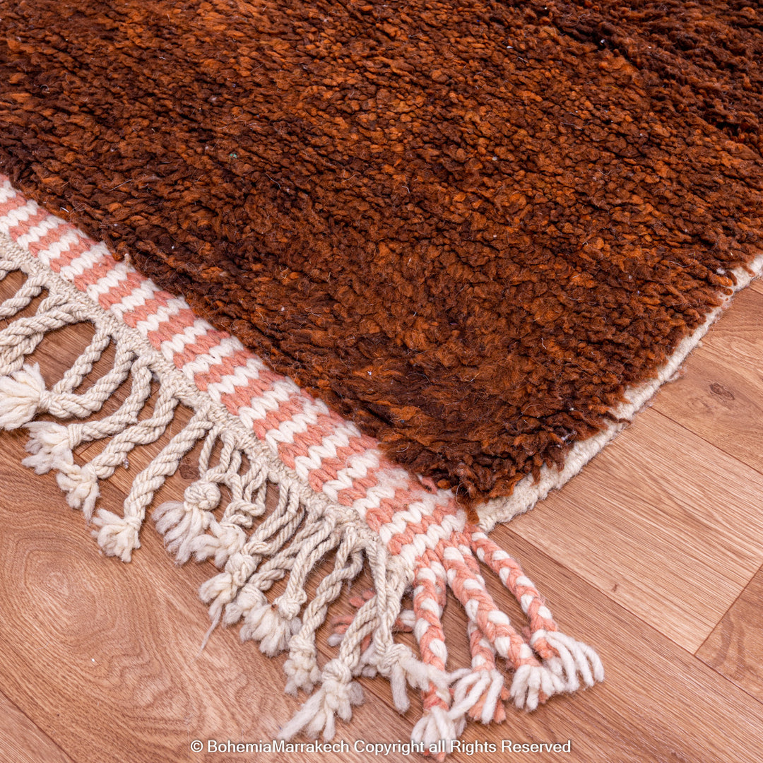 Desert-inspired Moroccan rug with earthy red and brown abstract mountain motifs, handmade from 100% wool
