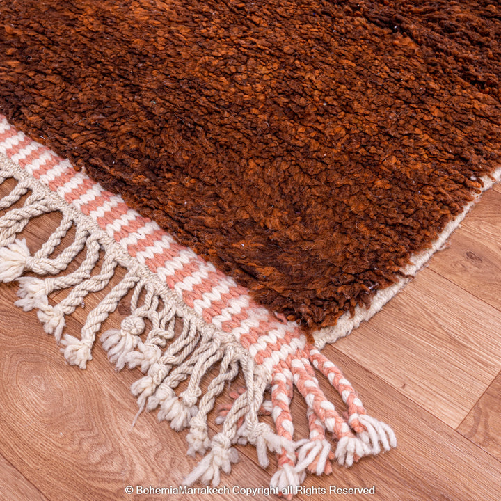 Desert-inspired Moroccan rug with earthy red and brown abstract mountain motifs, handmade from 100% wool