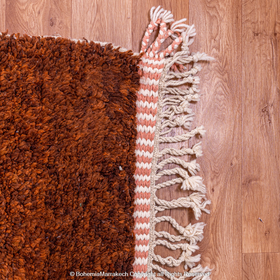 Desert-inspired Moroccan rug with earthy red and brown abstract mountain motifs, handmade from 100% wool
