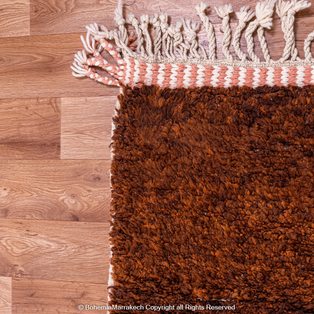 Desert-inspired Moroccan rug with earthy red and brown abstract mountain motifs, handmade from 100% wool