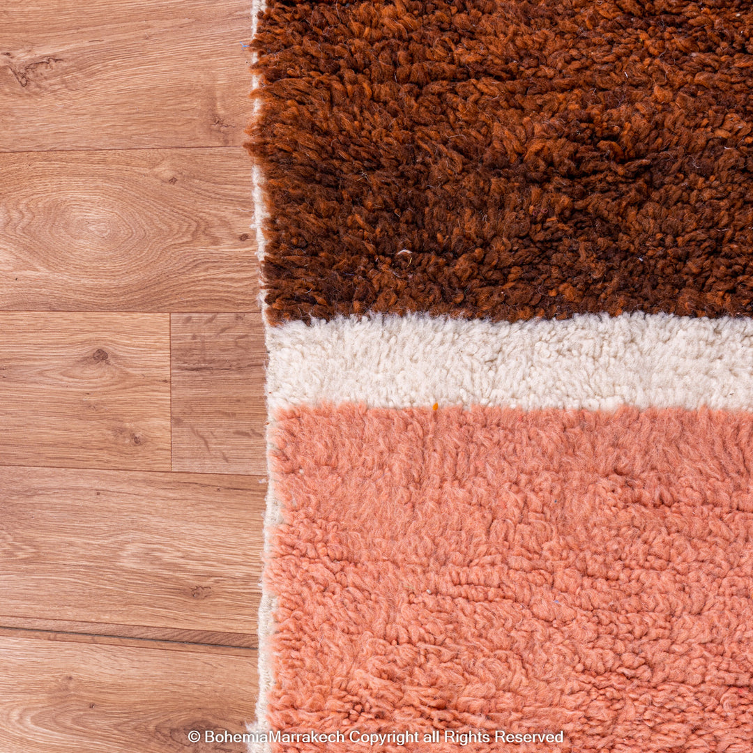 Desert-inspired Moroccan rug with earthy red and brown abstract mountain motifs, handmade from 100% wool