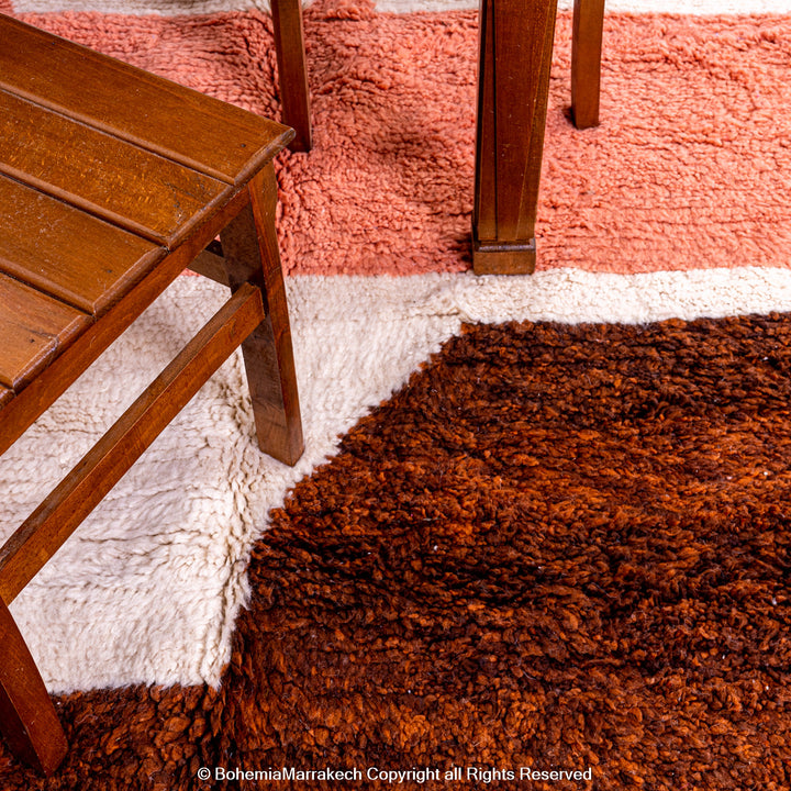 Desert-inspired Moroccan rug with earthy red and brown abstract mountain motifs, handmade from 100% wool
