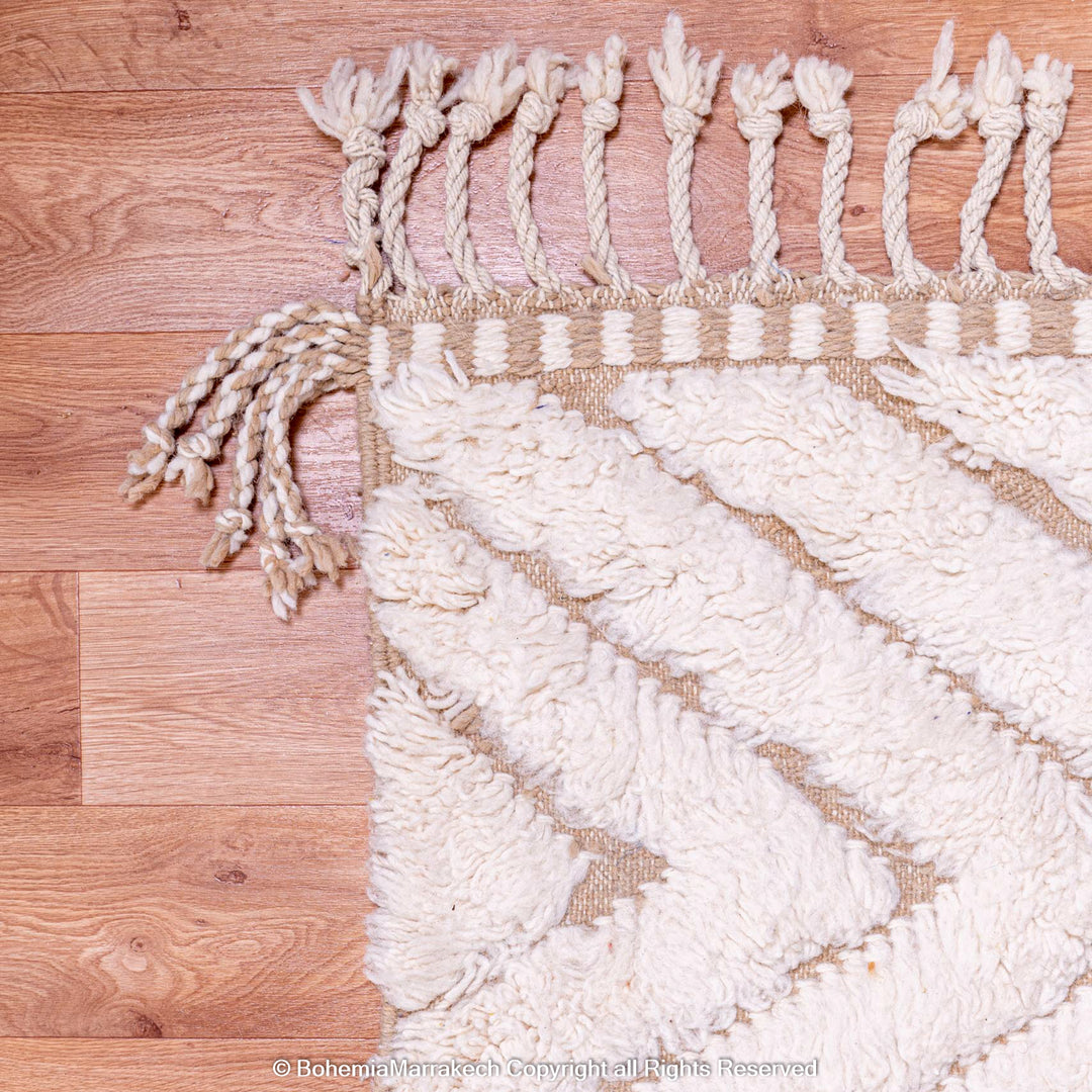 Handmade Beni Ourain Moroccan rug with geometric zigzag pattern in natural wool, perfect for adding warmth and texture to any room.