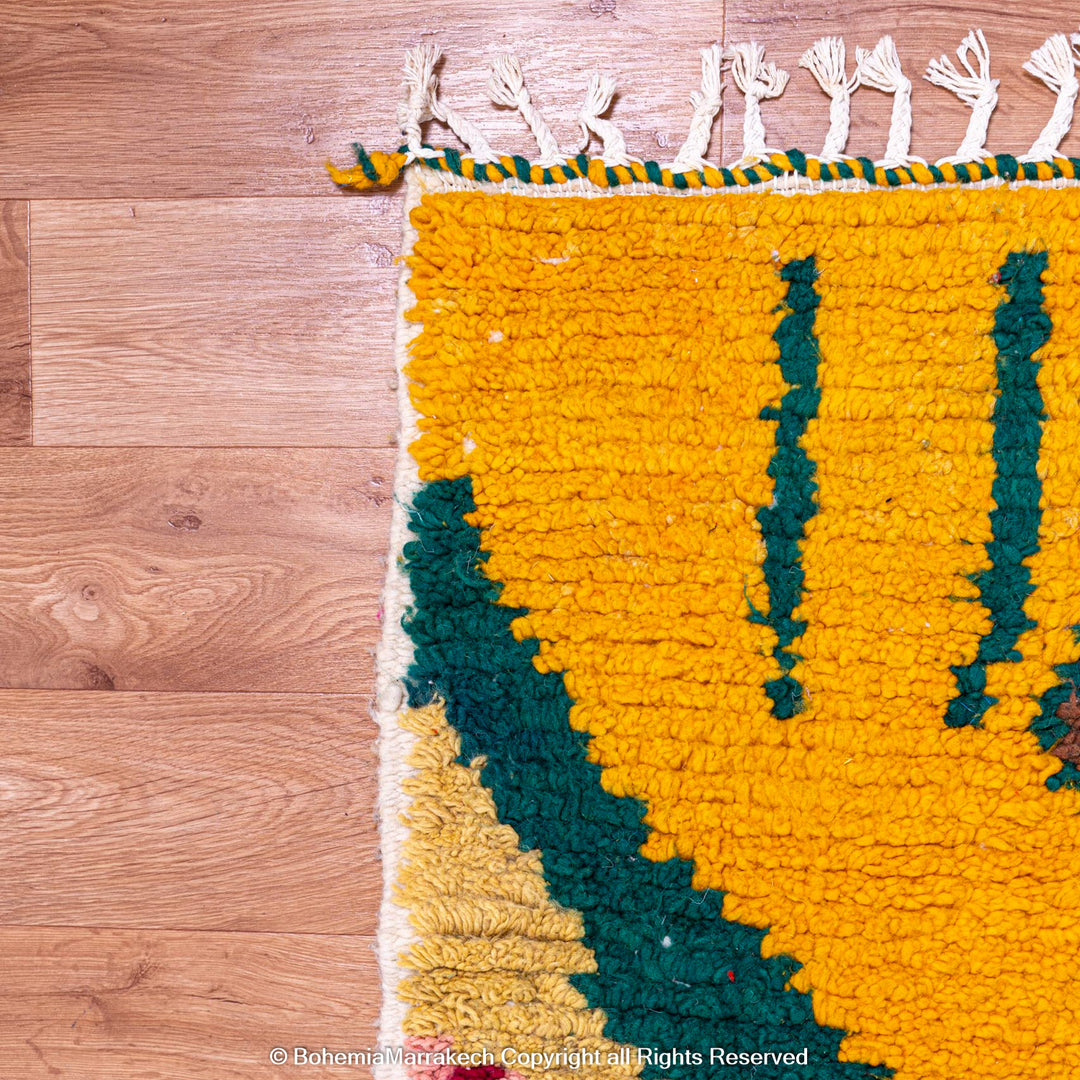 Custom Beni Ourain Moroccan rug with vibrant yellow and green geometric patterns, handmade from premium wool, on wooden floor.