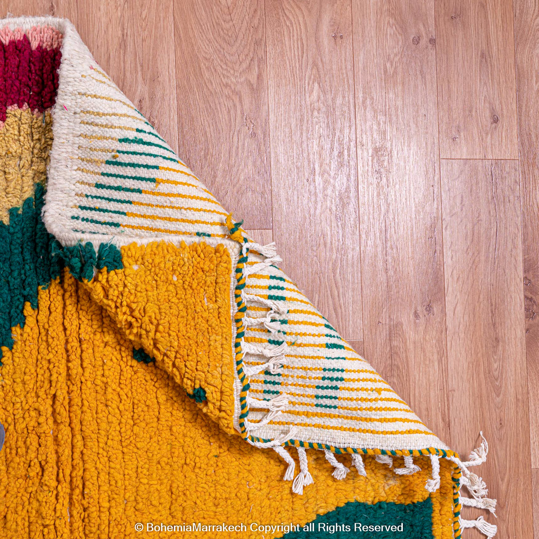 Custom Beni Ourain Moroccan wool rug with yellow, green, and pink geometric patterns for modern interior design.