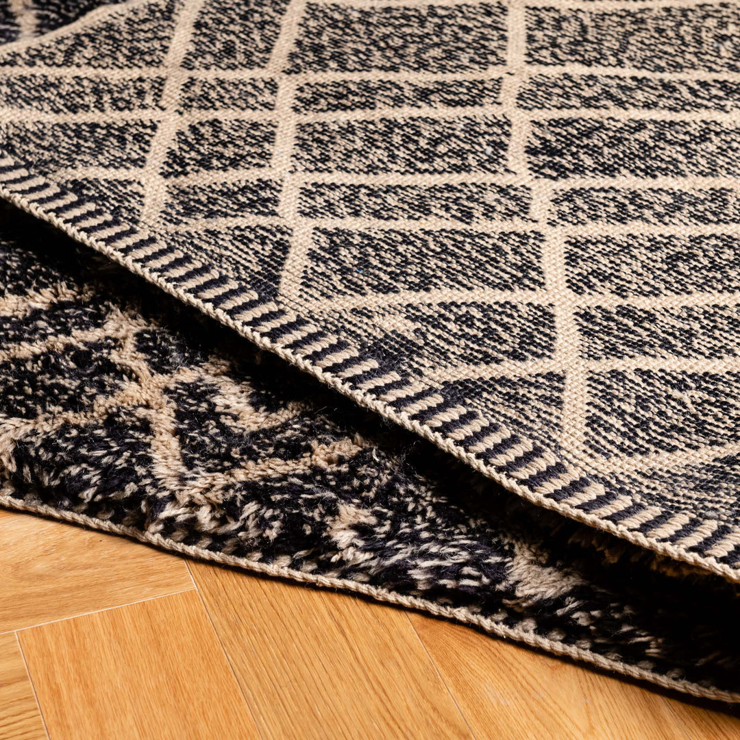 Close-up of Black Diamond Pattern Beni Mrirt Moroccan rug showcasing detailed craftsmanship and dense wool texture on wooden floor.