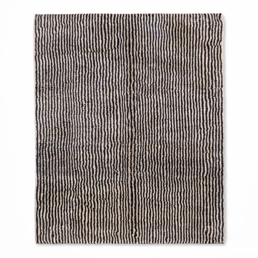 Handmade Moroccan wool rug with black and ivory stripes for modern interiors. Elevate spaces with this timeless 8x10 area rug.
