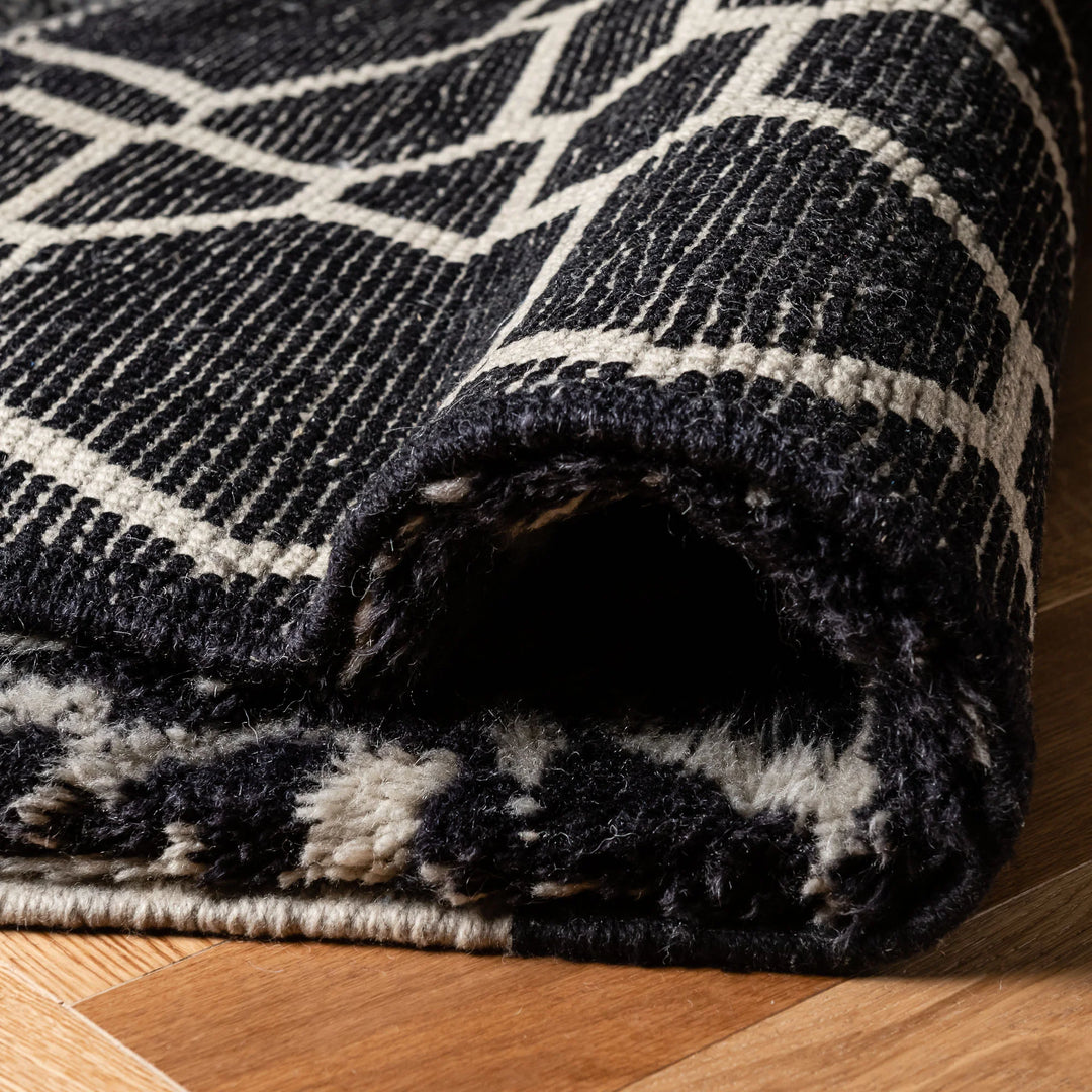 Handmade black and white Moroccan wool rug, featuring a bold abstract design. Perfect for modern interiors. Moroccan berber rug.