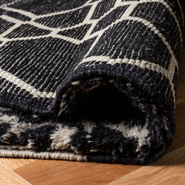 Handmade black and white Moroccan wool rug, featuring a bold abstract design. Perfect for modern interiors. Moroccan berber rug.