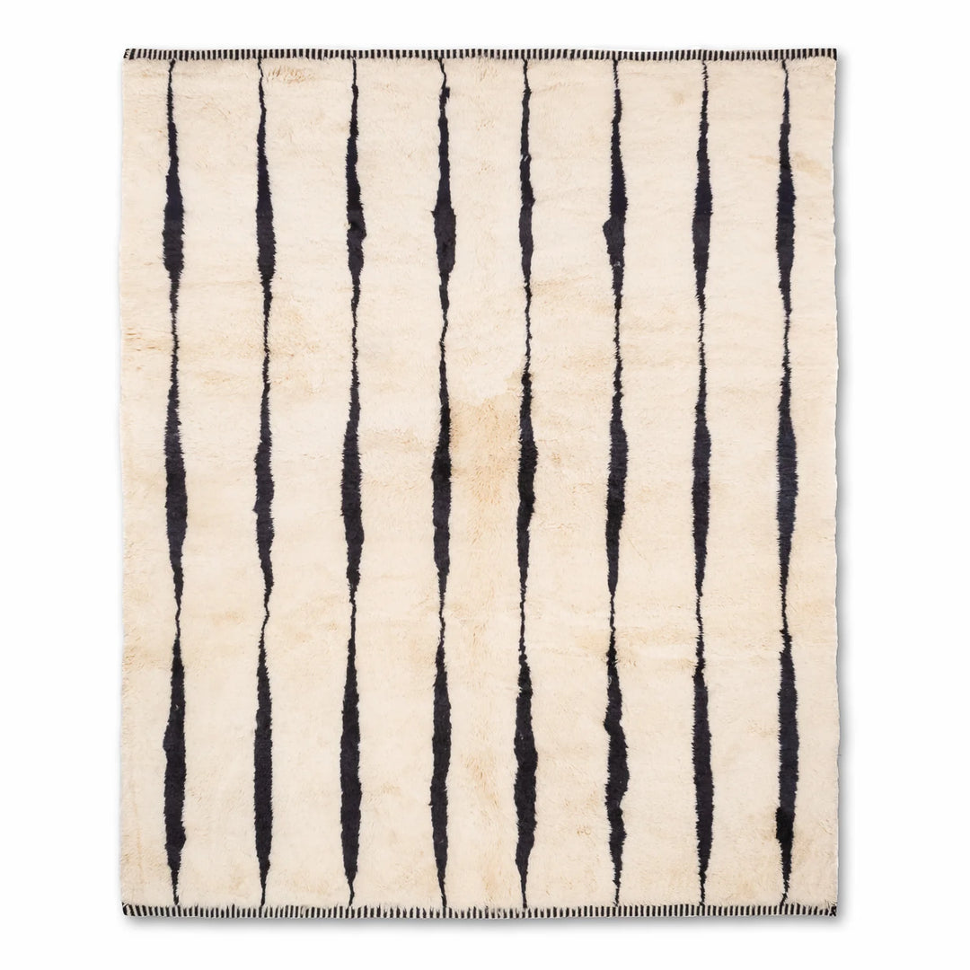 Black and white Moroccan wool rug with vertical stripes, traditional Berber design, ideal for contemporary interiors.