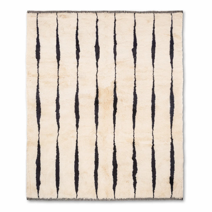 Black and white Moroccan wool rug with vertical stripes, traditional Berber design, ideal for contemporary interiors.