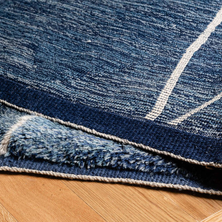 Close-up of Blue Moroccan Beni Mrirt Rug with ivory geometric lines, showcasing texture and artistry. Luxurious wool rug from Morocco.
