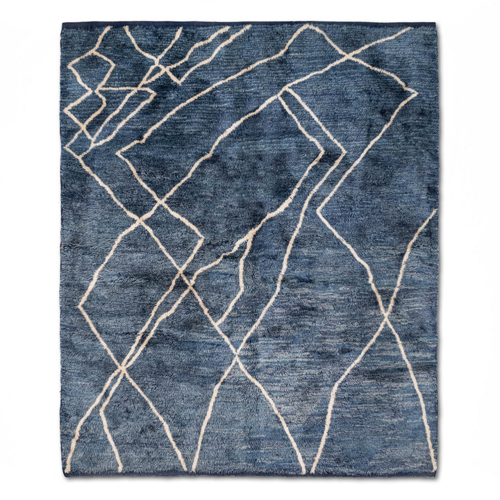 Blue Moroccan Beni Mrirt Rug with ivory geometric lines on denim-blue background. Handwoven wool, elegant Moroccan rug for modern spaces.