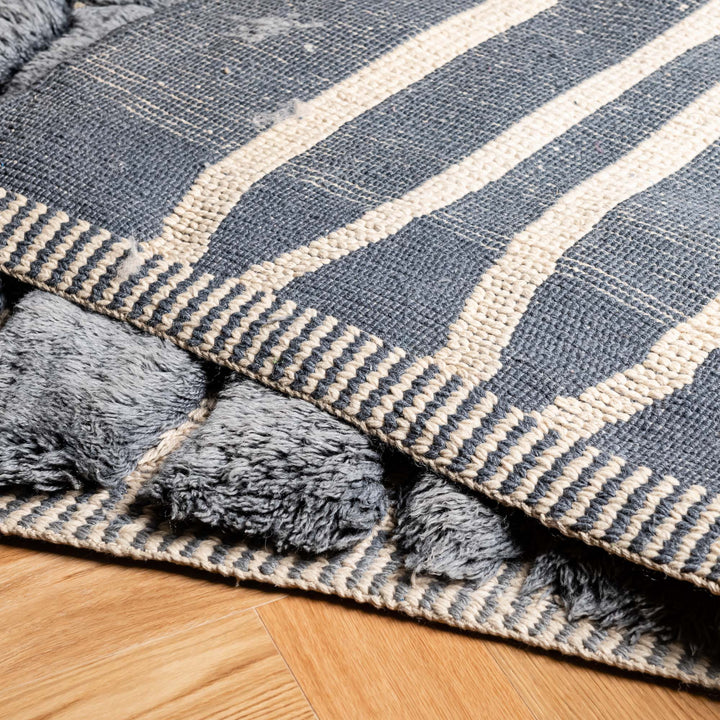 Charcoal grey handwoven Moroccan wool rug with ivory accents, showcasing plush texture and artisanal design. Perfect Moroccan Berber carpet.