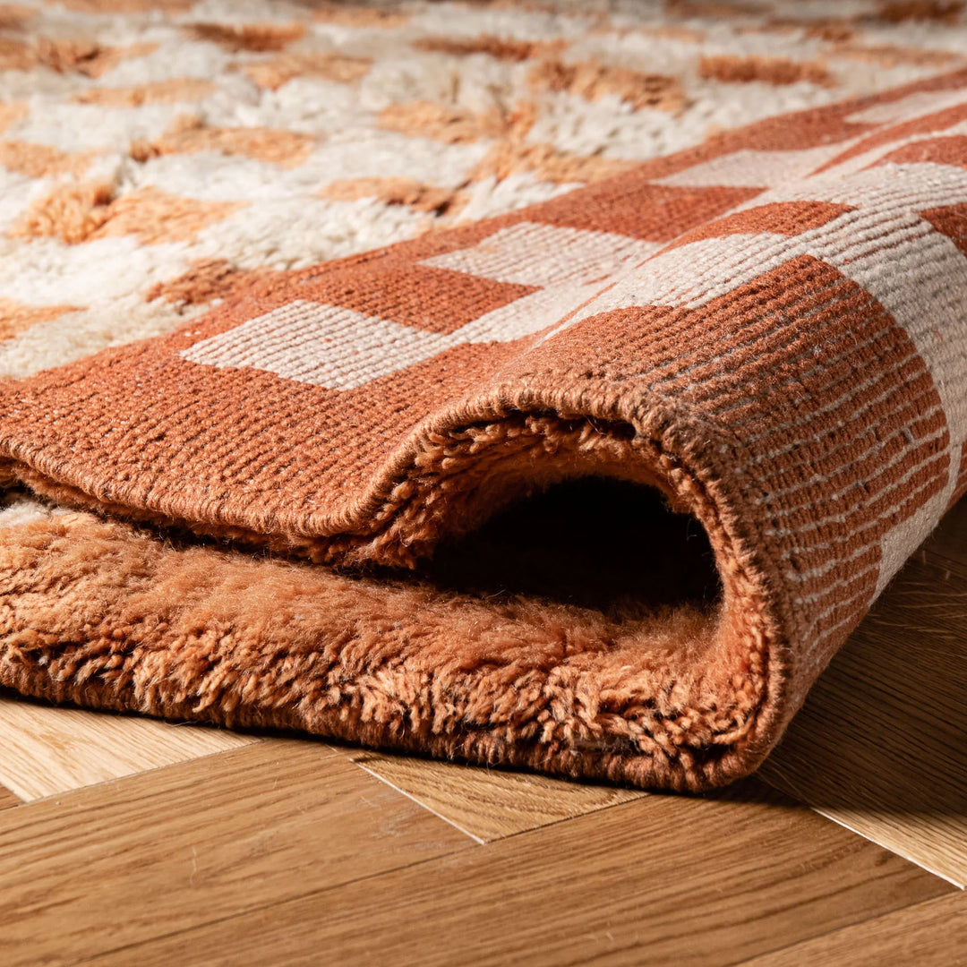 Handmade checkered Moroccan wool rug with textured shag finish, ideal as a traditional Moroccan area rug or runner.