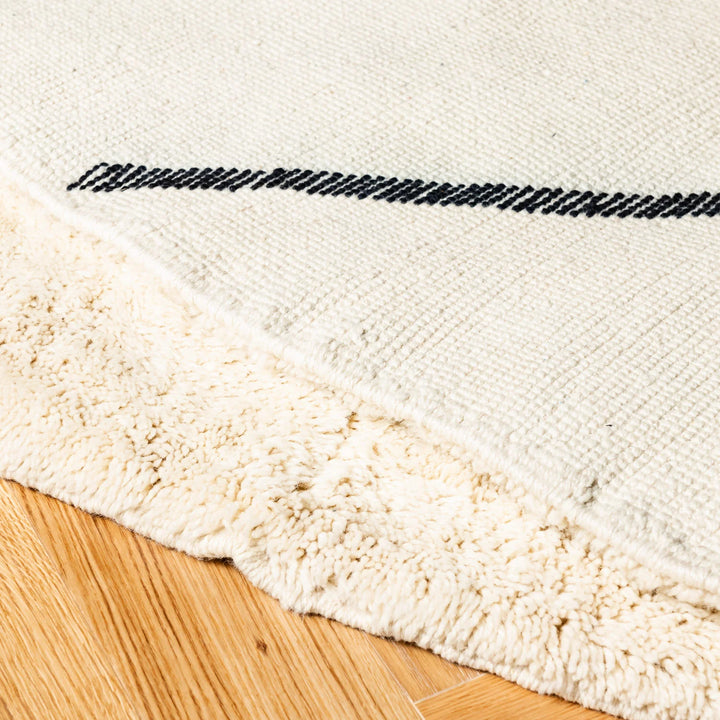 Classic Diamond Beni Mrirt Moroccan wool rug with black lozenge design on ivory base, showcasing intricate handwoven detail.