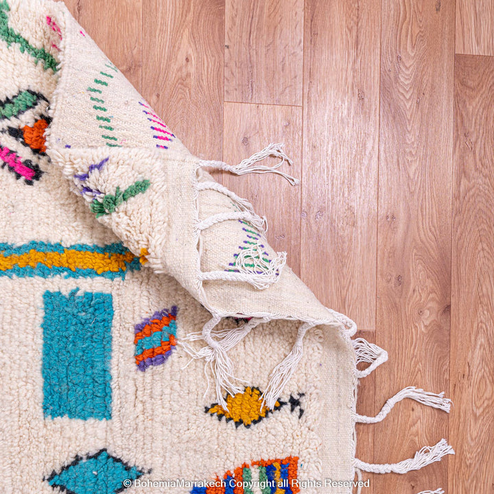 Colorful Azilal Moroccan rug, handmade Berber wool art, vibrant shapes on natural background, traditional Moroccan carpet.