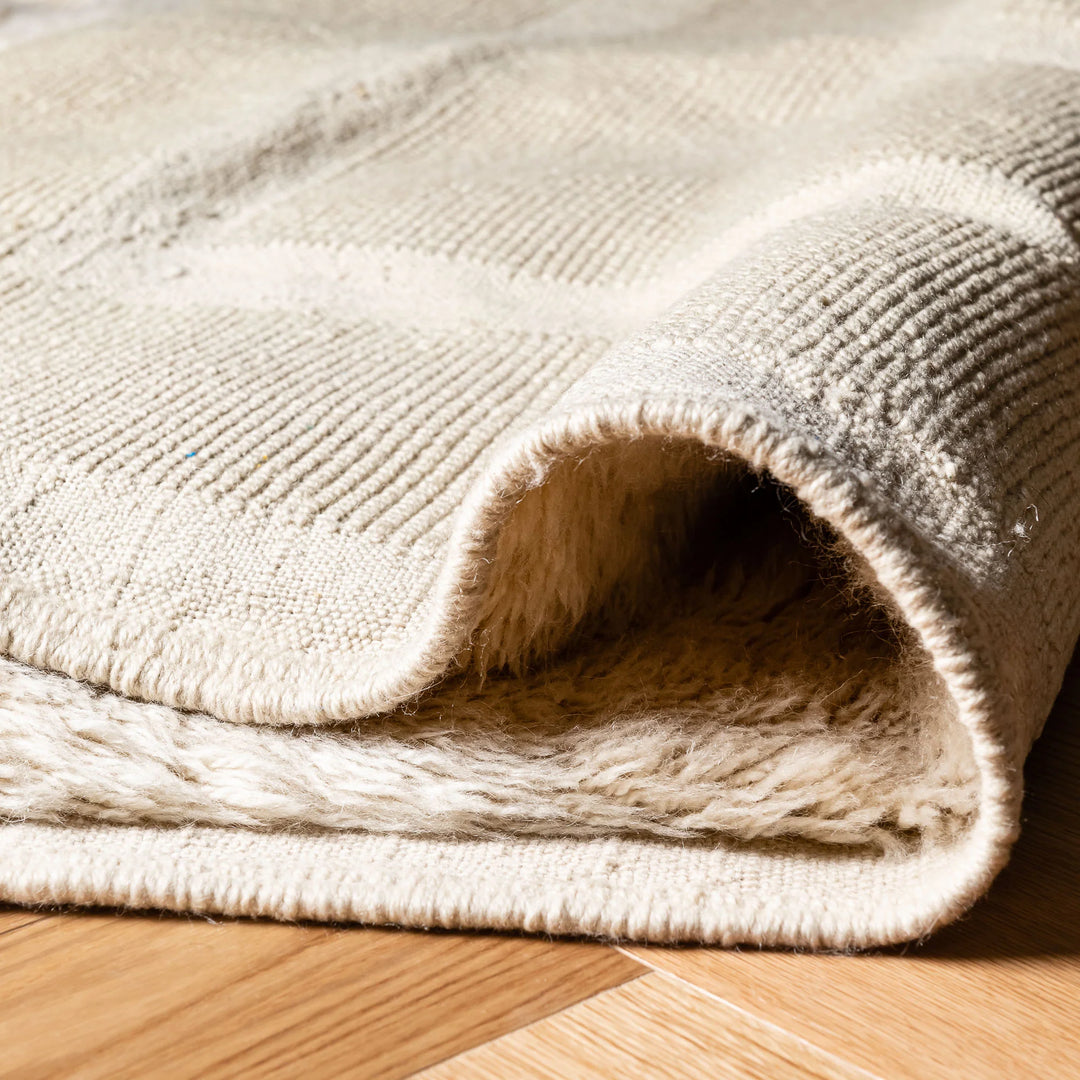 Close-up of a cream geometric Beni Mrirt rug made from natural wool, showcasing its plush texture and handwoven Moroccan design.