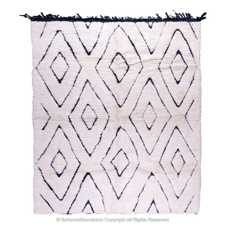 Handmade black and white diamond Moroccan wool rug with traditional Berber design, perfect for modern or boho interiors.